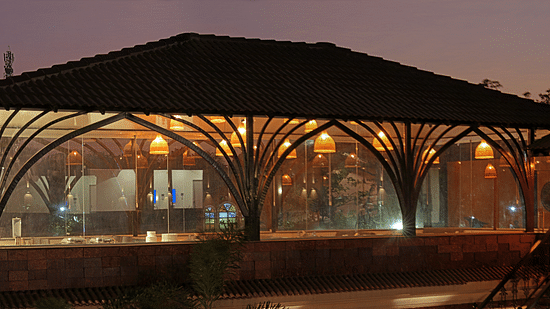 Flavours restaurant exterior view with warm light in Grand Continent, Anjuna - A Sarovar Portico Affiliate Hotel